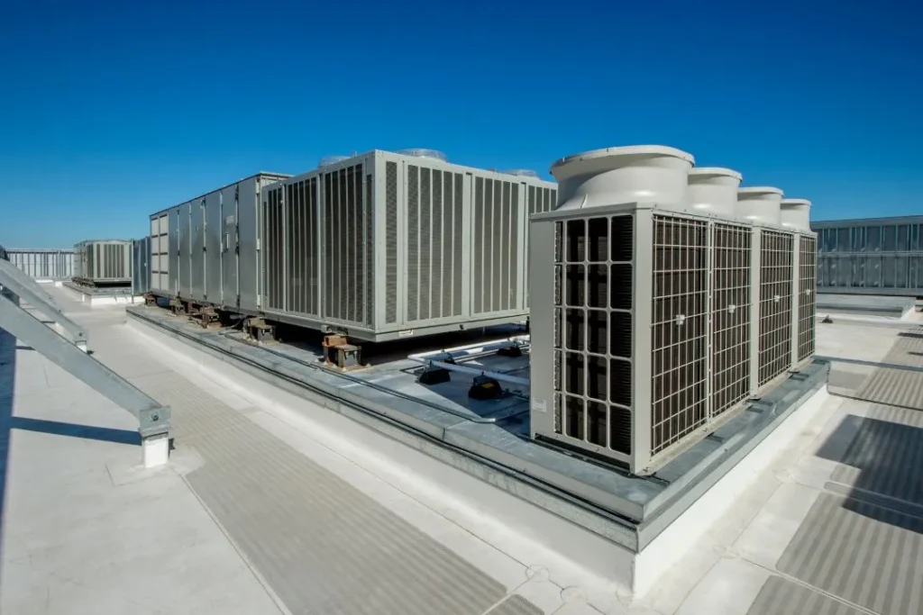 Rooftop commercial HVAC units under blue sky.